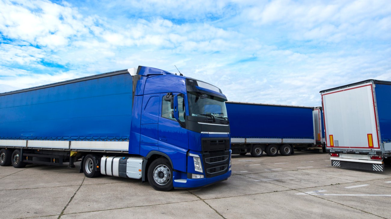 Truck vehicle with trailers in background.